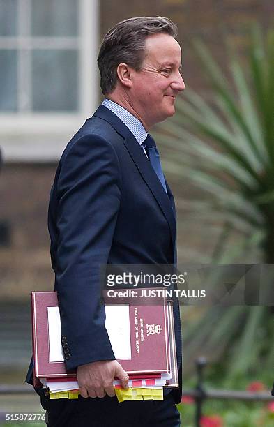 British Prime Minister David Cameron leaves 10 Downing Street in London, on March 16 as British Chancellor of the Exchequer George Osborne prepares...