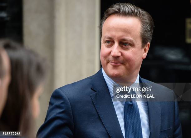 British Prime Minister David Cameron leaves 10 Downing Street in London, on March 16 as British Chancellor of the Exchequer George Osborne prepares...