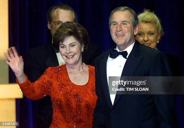 President George W. Bush and US First Lady Laura Bush arrive on stage at their first Inaugural Ball of the evening at the Ronald Reagan Building 20...