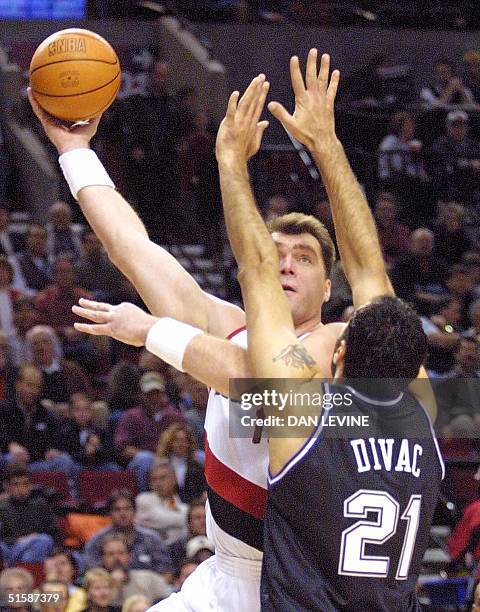 Portland Trail Blazers' Arvidis Sabonis launches a hook shot over Sacramento Kings' Vlade Divac during first quarter action of their game in Portland...
