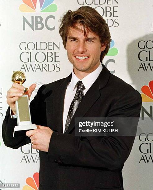 Actor Tom Cruise holds his award for Best Actor in a Motion Picture Comedy for his role in "Jerry Maguire" 19 January at the 54th Annual Golden Globe...