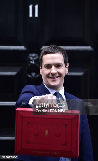 British Finance Minister George Osborne poses for pictures with the Budget Box as he leaves 11 Downing Street in London, on March 16 before...