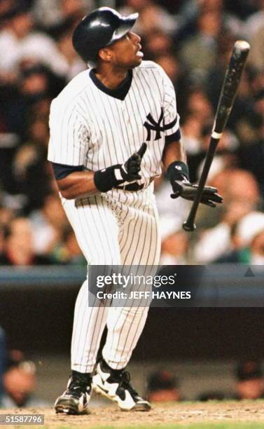 New York Yankees' Bernie Williams watches his game-winning home run leave the park in the eleventh inning of the Yankees' 5-4 win over the Baltimore...