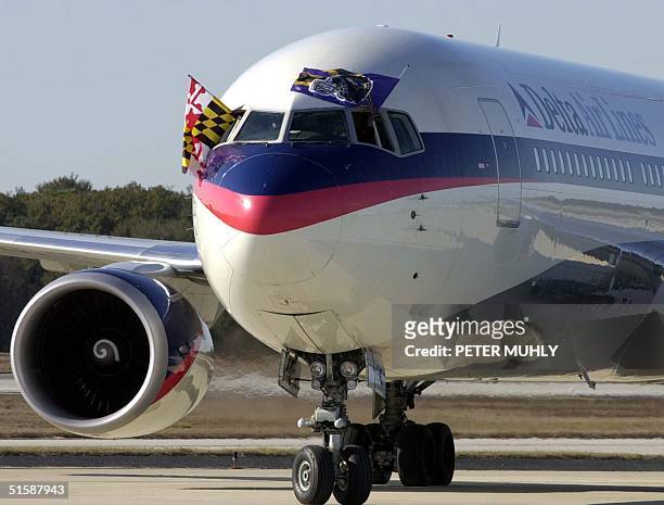 The Delta Airlines flight carrying the Baltimore Ravens arrives at the Tampa International Airport in Tampa 22 January, 2001. The Ravens will start...