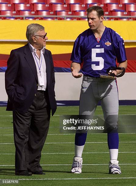 New York Giants Chairman and CEO Preston Robert Tisch talks with quarterback Kerry Collins 23 January, 2001 during media day for Super Bowl XXXV at...