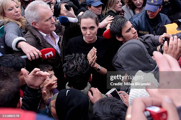 Special envoy of the United Nations High Commissioner for Refugees, Angelina Jolie talks to young migrants during her visit to the temporary refugee...