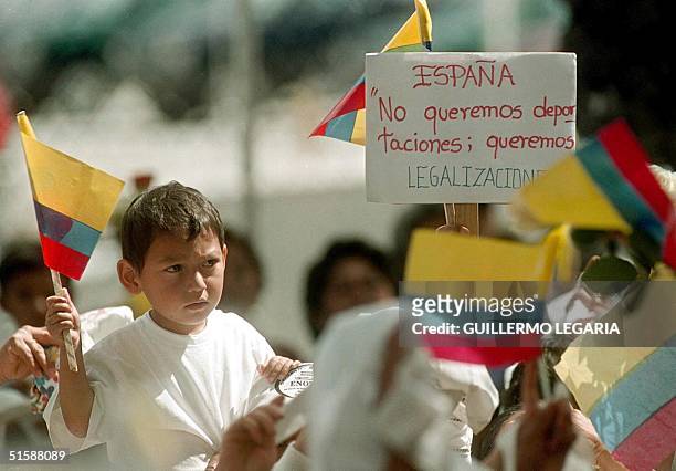 Child carries an Ecuadoran flag in a demonstration by hundreds of relatives of Ecuadorans living in Spain as they demonstrate in front of the Spanish...