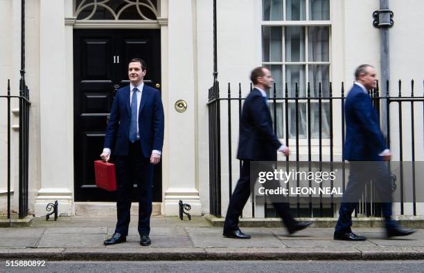 British Finance Minister George Osborne poses for pictures with the Budget Box as he leaves 11 Downing Street in London, on March 16 before...