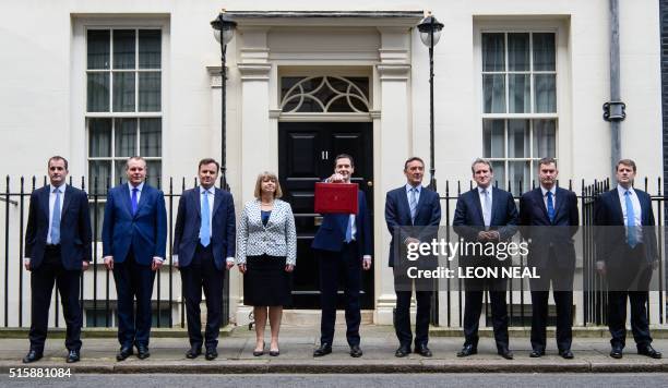 British Finance Minister George Osborne holds the Budget Box as he poses for pictures with members of the Treasury team as he leaves 11 Downing...