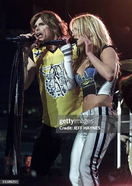 Steven Tyler of the rock group Aerosmith and singer Britney Spears perform during the halftime show at the Super Bowl XXXV 28 January 2001 at Raymond...