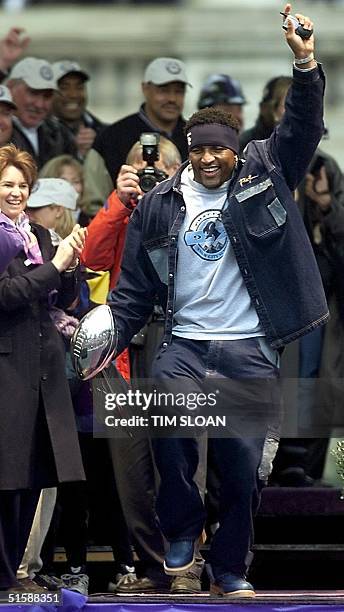 Ray Lewis of the Baltimore Ravens, Super Bowl XXXV Most Valuable Player, dances on stage with the Vince Lombardi Trophy during a victory parade and...