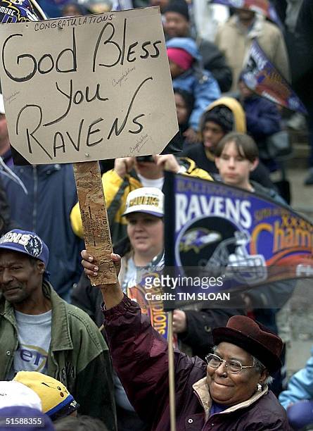 Woman holds a sign congratulating her Super Bowl XXXV champion Baltimore Ravens during a victory parade and celebration for the team and its fans in...