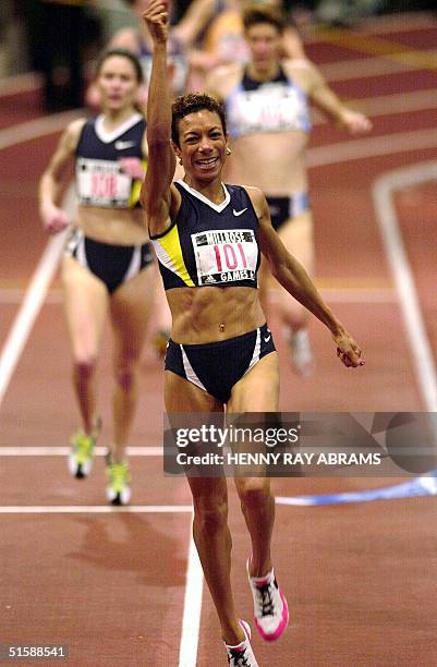 Regina Jacobs of the US celebrates after winning the Women's Mile at the Millrose Games at Madison Square Garden in New York 02 February 2001....