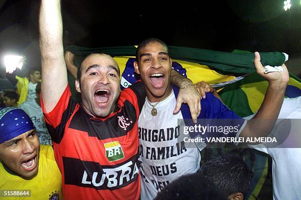 Brazilian player Adriano celebrates with a supporter of Flamengo de Rio de Janeiro, the champ title for the XX South American Football Sub 20...