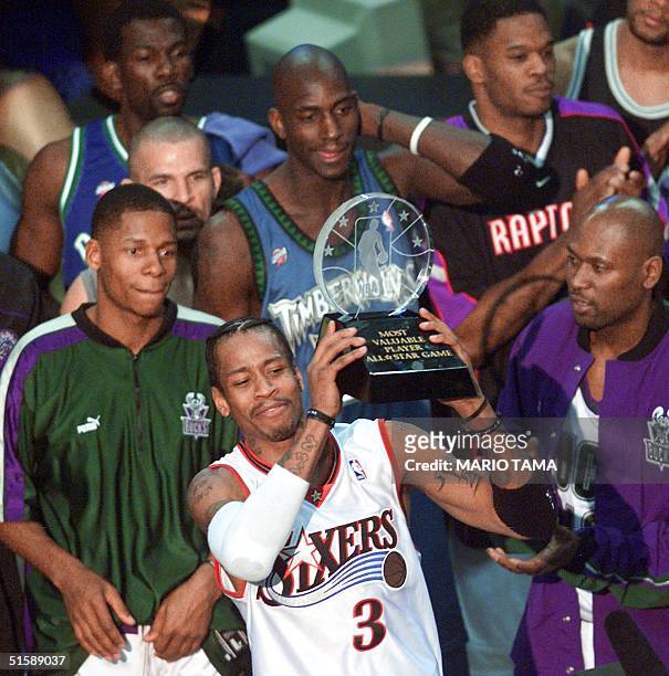 Philadelphia 76ers' guard Allen Iverson stands with his fellow NBA All-Stars and holds his MVP trophy for his performance in the 2001 NBA All-Star...