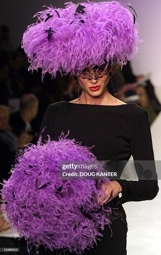 A model wears a black crepe long-sleeve dress with