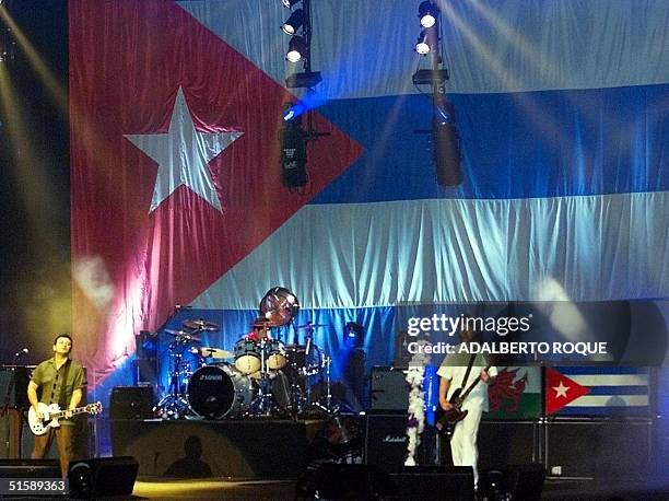 The British rock band Manic Street Preachers performs on the stage of the Karl Marx Theater in Havana 17 February, 2001 with the Cuban flag as a...