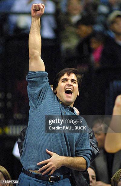 Dallas Mavericks' owner Mark Cuban celebrates a Mavericks' three-point play to end the first half of play versus the Boston Celtics at Reunion Arena...