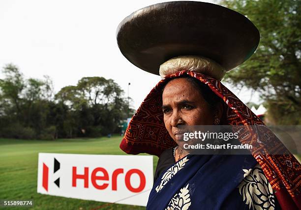 Local lady who helps maintain the golf course is seen prior to the start of the Hero Indian Open golf at Delhi Golf Club on March 16, 2016 in New...