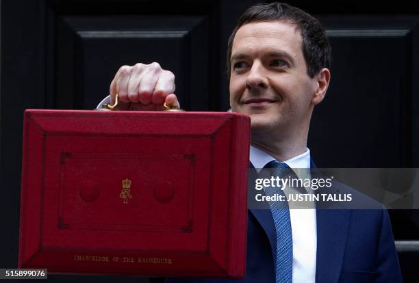 British Finance Minister George Osborne poses for pictures with the Budget Box as he leaves 11 Downing Street in London, on March 16 before...