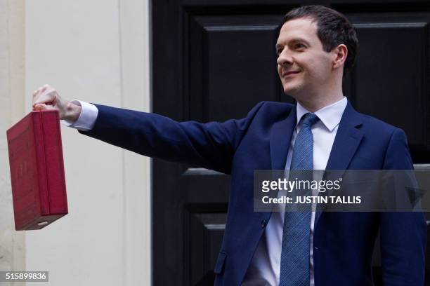 British Finance Minister George Osborne poses for pictures with the Budget Box as he leaves 11 Downing Street in London, on March 16 before...