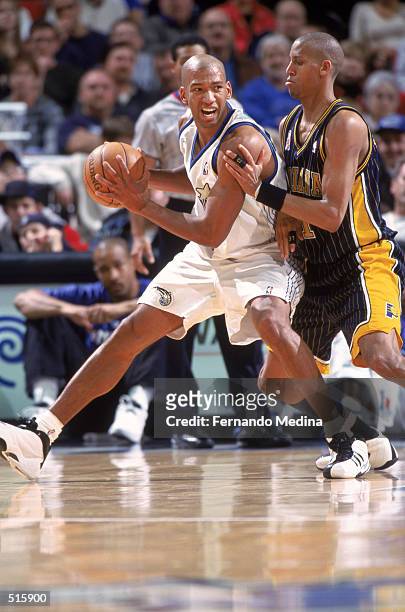 Forward Monty Williams of the Orlando Magic posts up guard Reggie Miller of the Indiana Pacers during the NBA game at TD Waterhouse Centre in...
