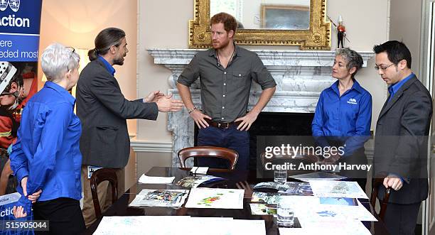 Prince Harry speaks with MapAction volunteers Kirsty Ferns, Hamish Pritchard, MapAction Chief Executive Liz Hughes and volunteer Wai-Ming Lee during...