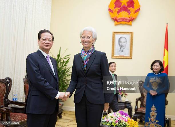 In this handout photo provided by the International Monetary Fund , International Monetary Fund Managing Director Christine Lagarde is greeted by...