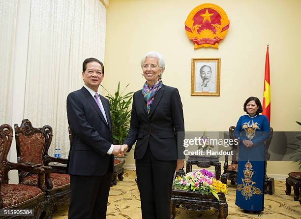 In this handout photo provided by the International Monetary Fund , International Monetary Fund Managing Director Christine Lagarde is greeted by...