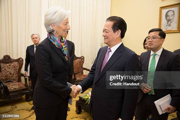 In this handout photo provided by the International Monetary Fund , International Monetary Fund Managing Director Christine Lagarde shakes hands with...