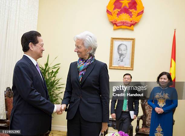 In this handout photo provided by the International Monetary Fund , International Monetary Fund Managing Director Christine Lagarde is greeted by...