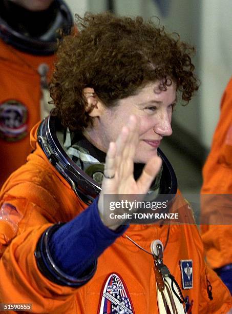 Space shuttle Discovery Mission Specialist Susan Helms waves as she departs the Operations and Checkout building and head to launch pad 39-B at the...