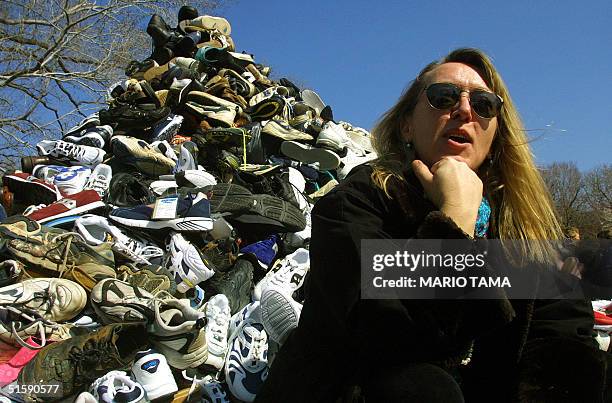 Nobel Peace Prize winner Jody Williams sits in front of donated shoes symbolizing landmine victims during "Ban Landmines Week" 08 March, 2001 on...