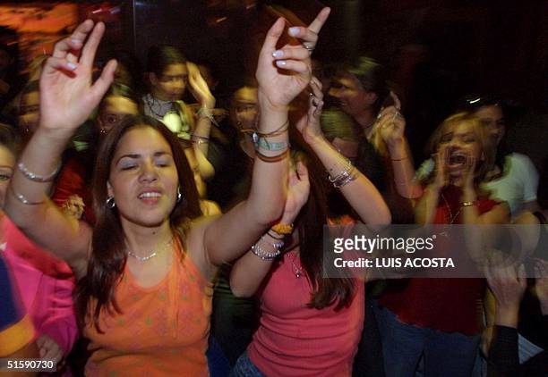 Many women dance in a night club of Bogota, Colombia, 09 March 2001, as the mayor decreed a women's night in the city and forbid men to go out from...