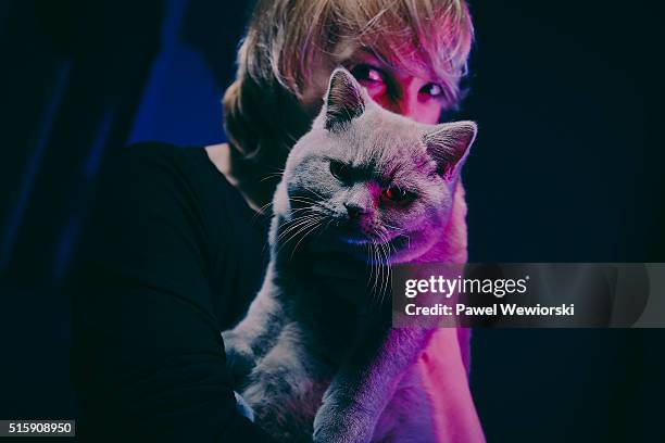 woman with cat - holding cat stock-fotos und bilder