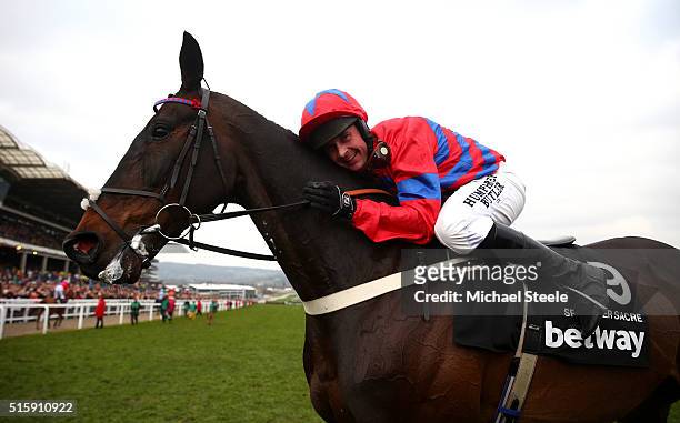 Nico de Boinville celebrates on board Sprinter Sacre after winning the Betway Queen Mother Champion Chase on Ladies Day of the Cheltenham Festival at...