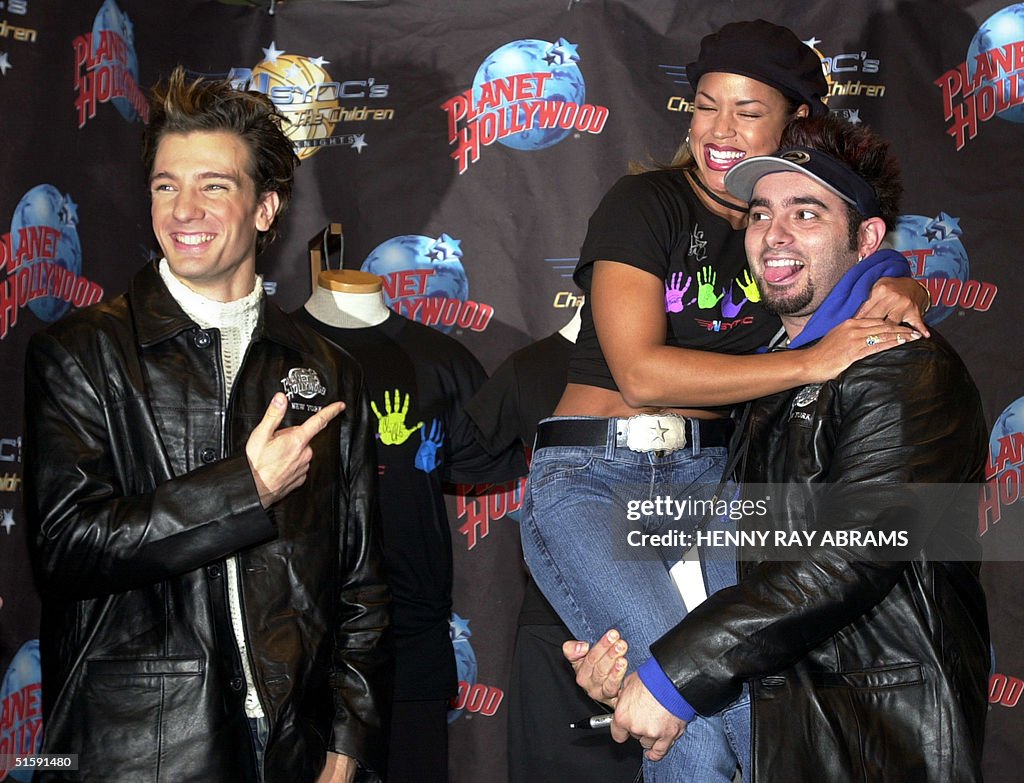 With fellow NSYNC member JC Chasez (L) pointing to