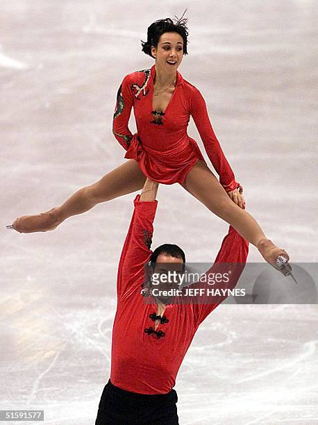 Stephane Bernadis of France lifts partner Sarah Abitbol during Pairs short program 19 March 2001, for the World Figure Skating Championships at GM...
