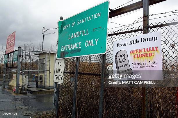 Sign outside the front gate marks the end of an era at the Fresh Kills Landfill as the final barge full of New York City trash arrived in Staten...