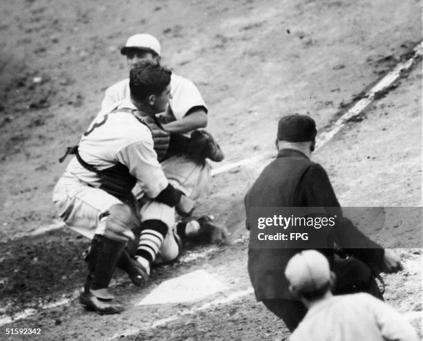 American baseball player Joe Medwick outfielder of the St. Louis Cardinals collides with Mickey Cochrane catcher of the Detroit Tigers as he slides...