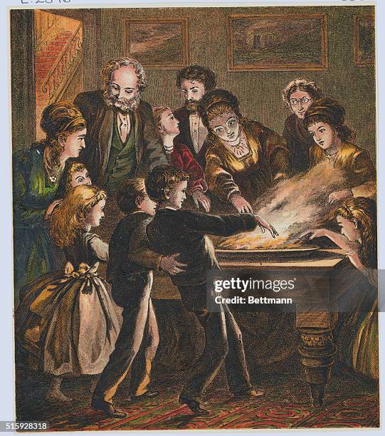 Victorian English family gathered around for the Chrismas custom of Snap Dragon.