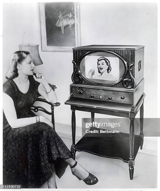 The "Americana" by Sightmaster...a new 15" Television Receiver with Dual Purpose Transparent Mirror...(This photograph shows how the television image...