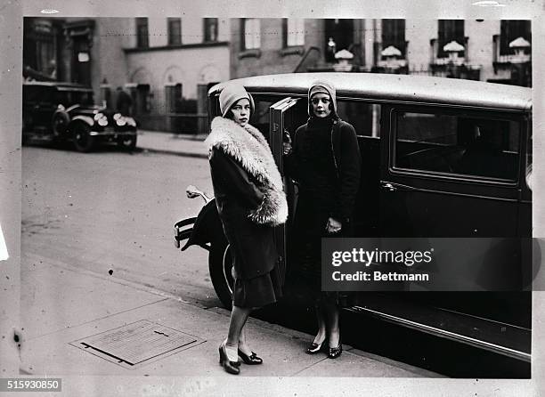 This photo shows Park Avenue, New York City Society belles in fur trim coats standing beside their automobile.