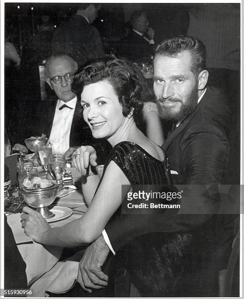 Hollywood, CA- That's no bearded prophet at the dinner table, Just Charlton Heston who's grown another beard for another Biblical role. His wife...
