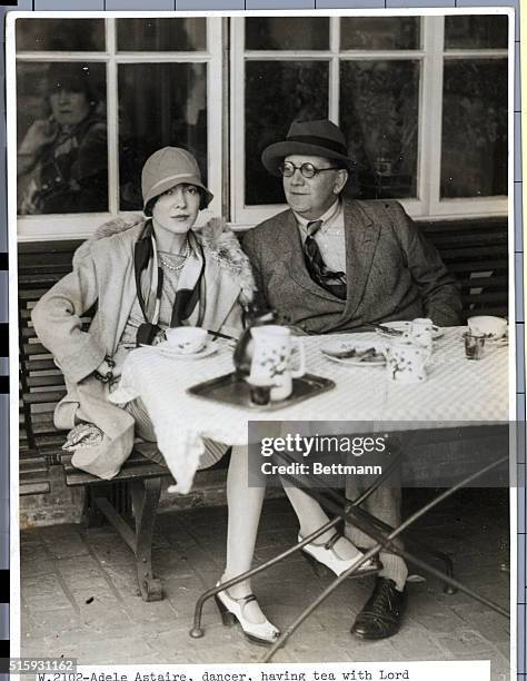 Adele Astaire, dancer, having tea with Lord Portarlington at Le Touquet Airpost, France.