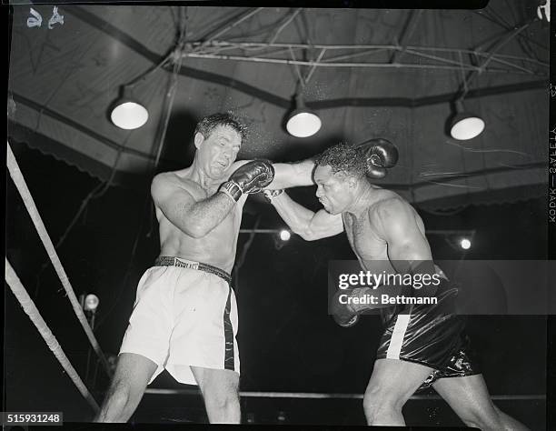 Miami, FL: Right is might. Taking a page from Joey Maxim's own book, Archie Moore used a stiff left jab followed by jolting rights to win a unanimous...