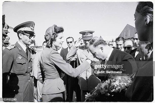 Tehran, Iran: Bending low, the Mayor of Tehran kisses the hand of Iran's Queen Soraya as she returns from Rome to rejoin her husband Shah Mohammed...