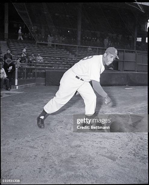 Brooklyn Dodgers pitcher Joe Black throws on the sidelines at a spring training game in Miami.