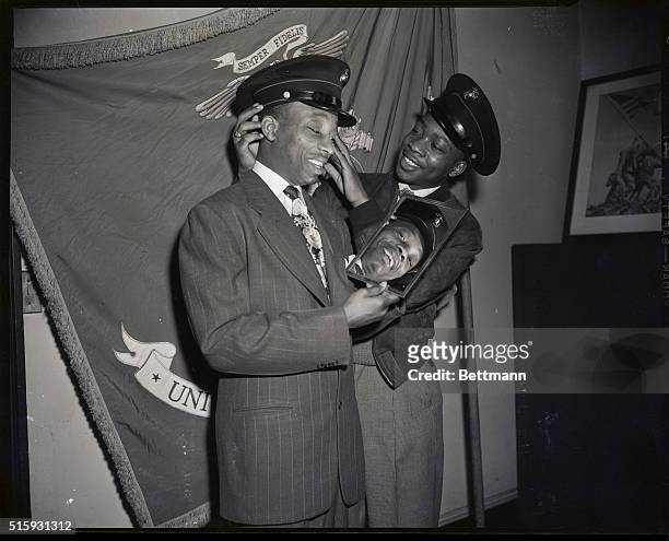 New York, NY: Sandy Saddler, featherweight champion who witnessed the swearing in to the the Marine Corps today of his younger brother George is...