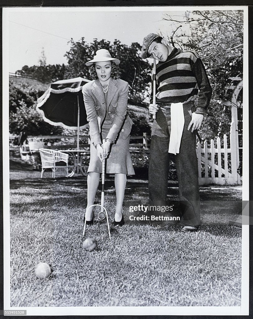 Woman Beating Man in a Game of Croquet